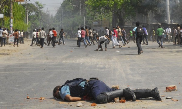 Jahangir Alam, officer in-charge of Upashahar police camp, lies on the street after Jamaat-e-Islami activists smashed pieces of bricks on his head during a clash in Rajshahi