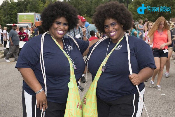 Perrena and Geneva Bernoudy, 36-year-old identical twins from Atlanta, Georgia, pose for a portrait at the 40th annual Twins Days Festival in Twinsburg, Ohio on August 8, 2015. Photo by Dustin Franz