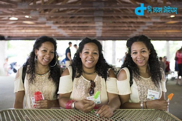 Identical triplets Latrina, Latasha and Latoya Thompson, 25 from Detroit Michigan, attend the Twins Days Festival for the first time. Photo by Dustin Franz