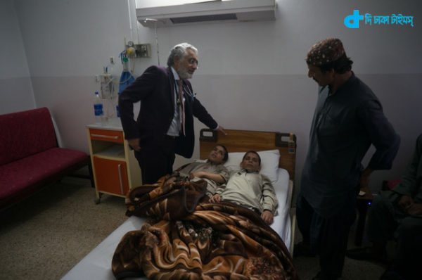 In this photo taken on Thursday, May 5, 2016, Pakistani Dr. Javed Akram, left, examines children Abdul Rasheed, 9,  centre  left, and Shoaib Ahmed, 13, at a hospital in Islamabad, Pakistan. The boys are normal active children during the day. But once the sun goes down, they both lapse into a vegetative state  unable to move or talk. Akram, told The Associated Press on Thursday that he had no idea what was causing the symptoms. (AP Photo/B.K. Bangash)