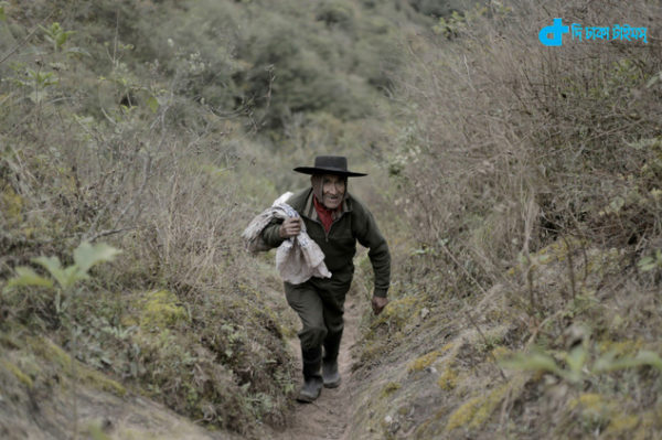 In this July 28, 2016 photo, Pedro Luca walks down the mountain to San Pedro de Colalao, in Argentina's northern province of Tucuman. Luca has lived in a cave in northern Argentina for 40 years. When he gets hungry he picks up his rifle and goes hunting or he goes on a three-hour trek down the mountain to the nearest settlement of San Pedro de Colalao. (AP Photo/Alvaro Medina)